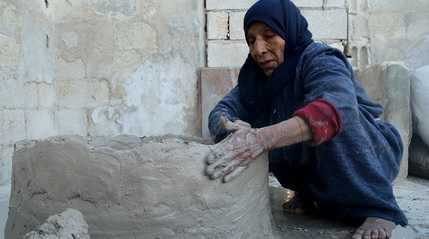 Syria grandmother builds clay oven