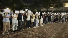 Protesters hold up blank white papers