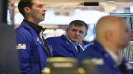 Traders work on the floor at the New York Stock Exchange