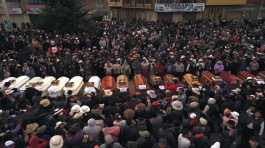 Residents surround coffins