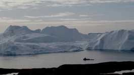 fishing vessel sails in the ice fjord 