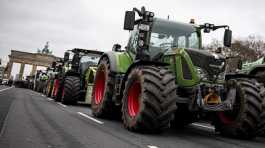 Farmers with tractors take part in a protest rally